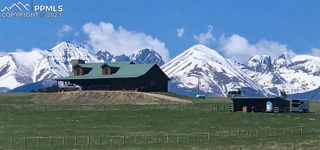85 Excelsior Road Silver Cliff, CO 81252 - Photo 4 of 27 a bed sitting in a yard next to a building