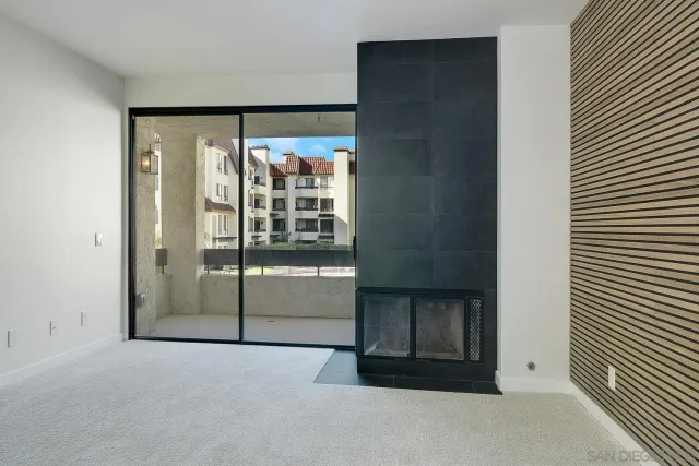 a view of an empty room with a fireplace