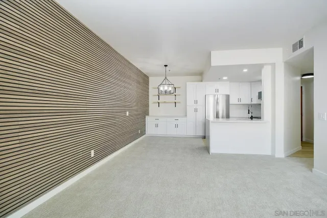 a view of a kitchen with refrigerator and a dishwasher