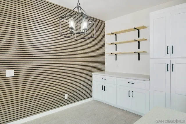 a view of a kitchen with white cabinets
