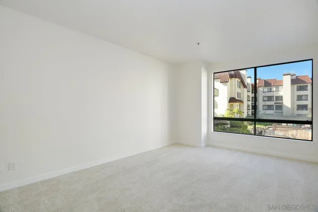 an empty room with large windows