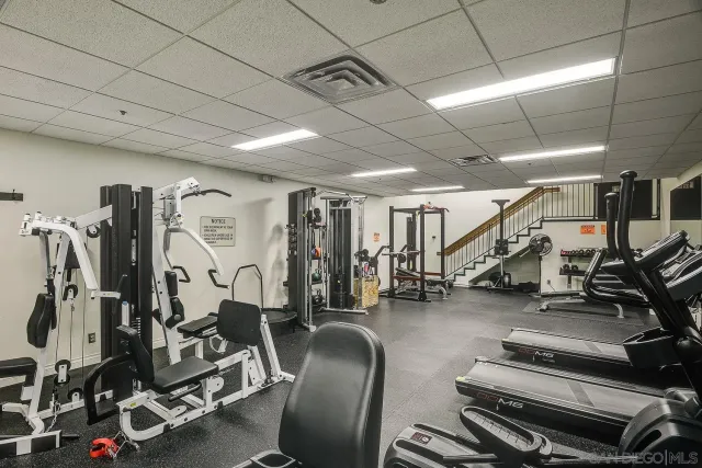 a front view of a building with fountain and chairs