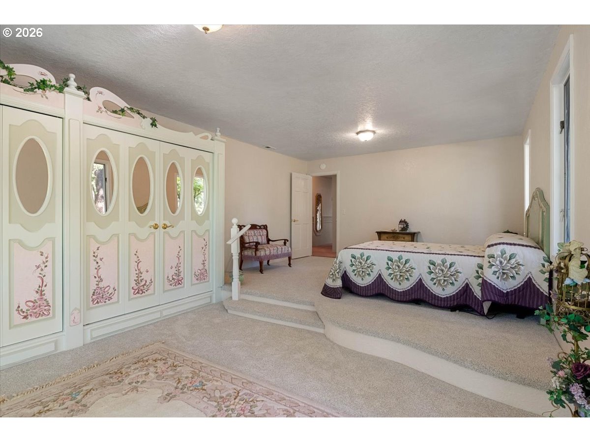 1300 Fair Oaks Road Oakland, OR 97462 - Photo 29 of 48 a bedroom with furniture and a chandelier