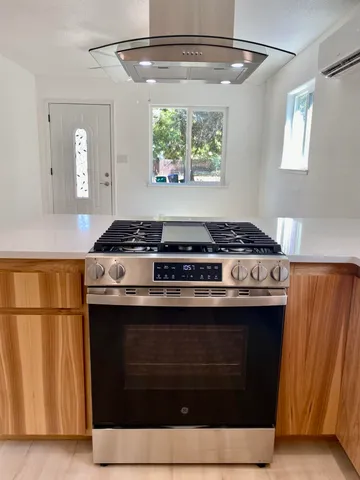 a kitchen with stainless steel appliances granite countertop a stove and a refrigerator