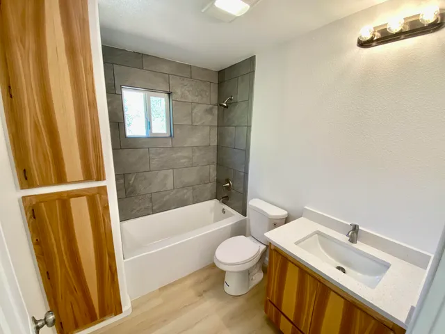 a bathroom with a sink a toilet and a bathtub