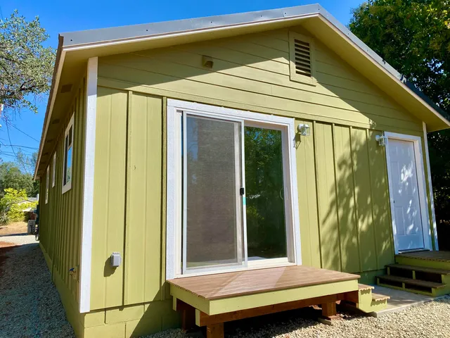 a yellow and red door in front of a house