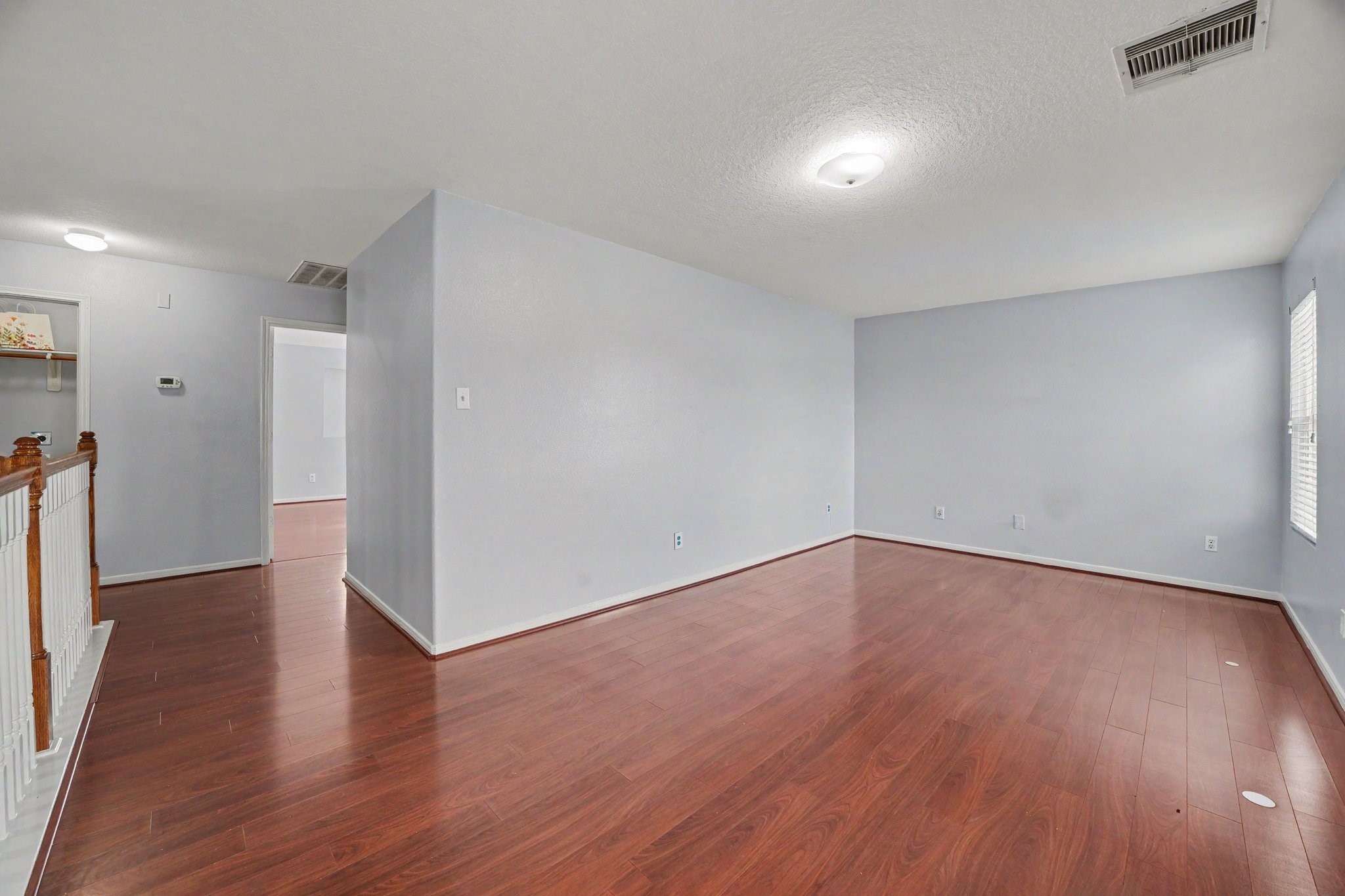 5622 Wasabi Lane Baytown, TX 77521 - Photo 19 of 29 a view of an empty room with wooden floor and a window