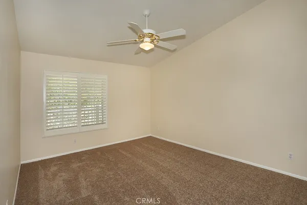 a view of a room with a ceiling fan and a window