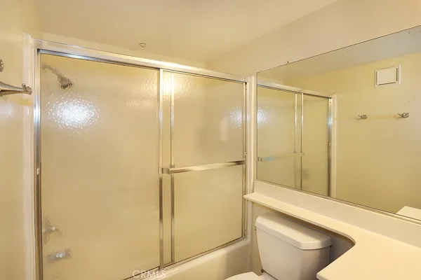 a bathroom with a shower and a toilet