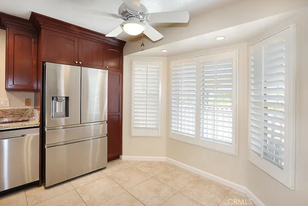 a kitchen with stainless steel appliances a refrigerator and microwave