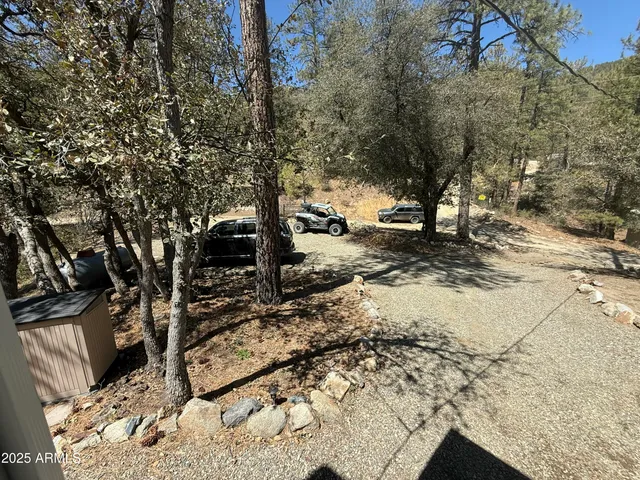 a view of a livingroom with furniture hardwood floor and a ceiling fan