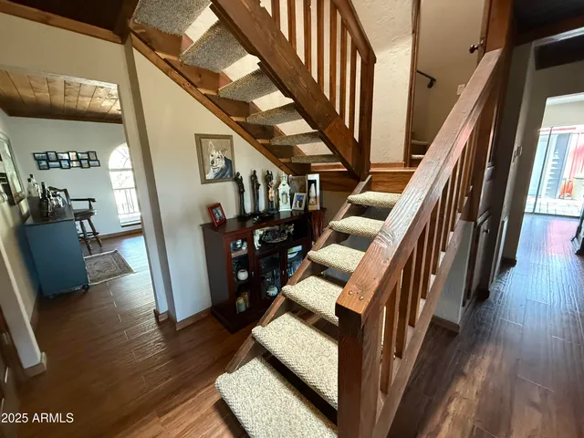 a front view of a house with trees covered with snow in front of house