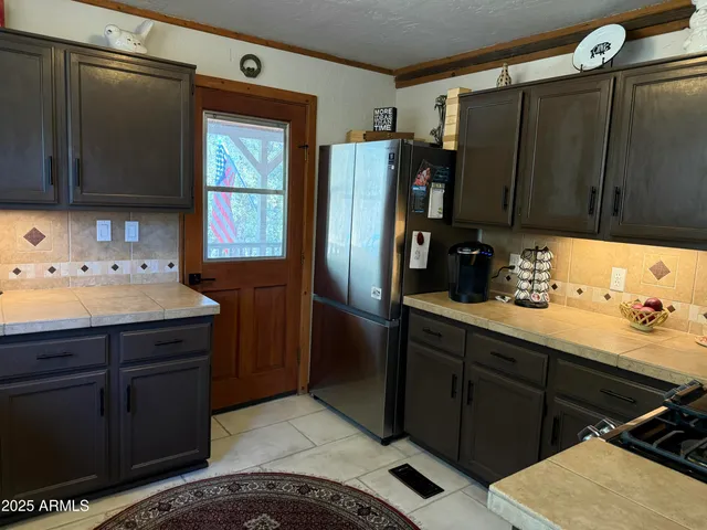 a large bed sitting in a bedroom next to a window