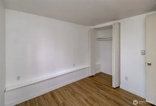 a view of wooden floor and brick walls