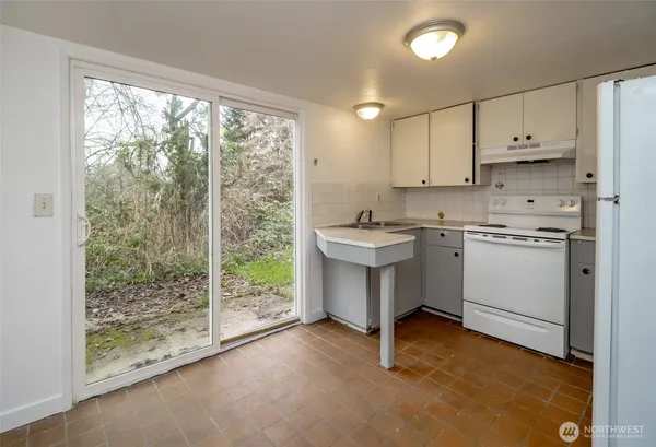 a view of a kitchen with sink and cabinets