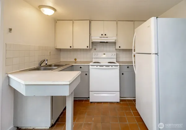a kitchen with a sink a stove and refrigerator