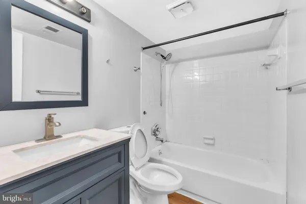 a bathroom with a sink a toilet and a bathtub