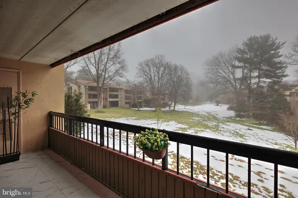 a view of a street with wooden fence