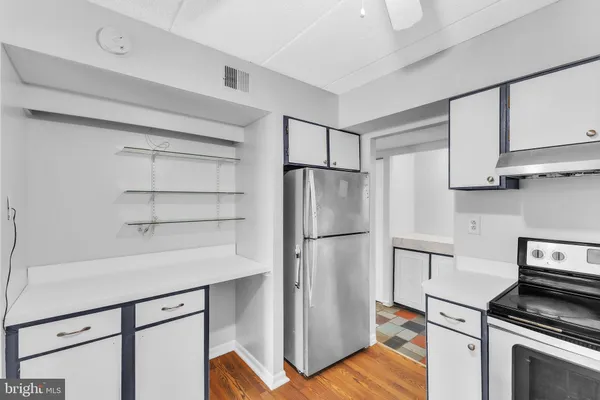a kitchen with cabinets and stainless steel appliances