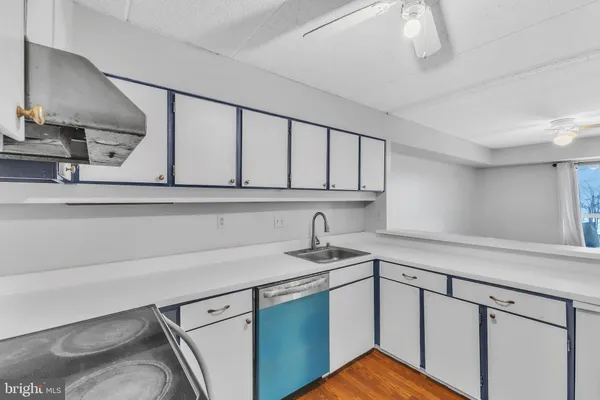 a kitchen with stainless steel appliances white cabinets and a sink