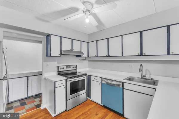 a kitchen with stainless steel appliances granite countertop a sink and cabinets