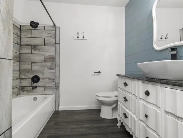 a bathroom with a sink a toilet and bathtub