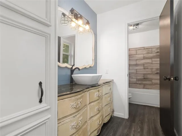 a bathroom with a sink a mirror and a shower