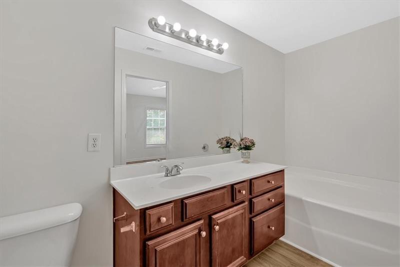 2555 Flat Shoals Road, Unit 1104 College Park, GA 30349 - Photo 27 of 33 a bathroom with a sink a toilet and shower