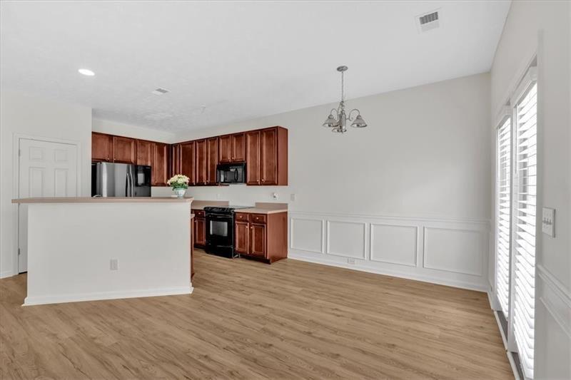 2555 Flat Shoals Road, Unit 1104 College Park, GA 30349 - Photo 7 of 33 a view of kitchen with cabinets and wooden floor