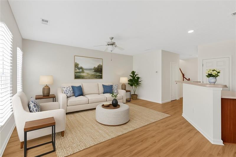 2555 Flat Shoals Road, Unit 1104 College Park, GA 30349 - Photo 8 of 33 a living room with furniture and a potted plant