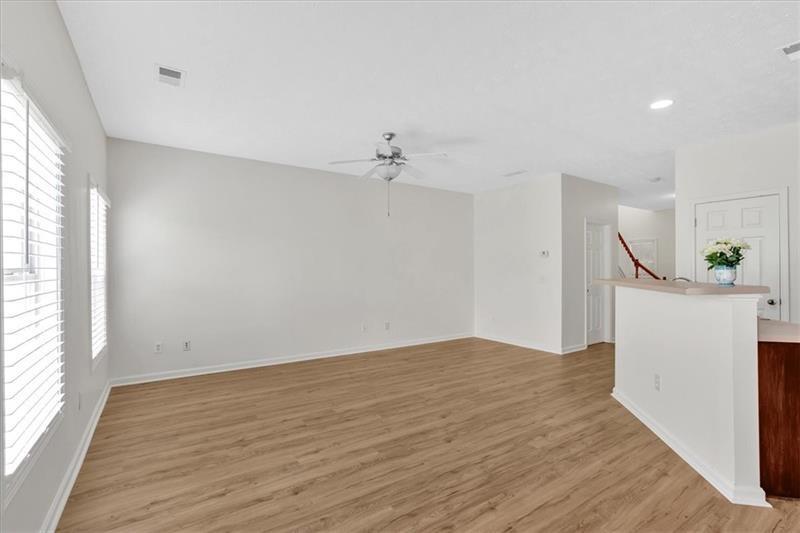 2555 Flat Shoals Road, Unit 1104 College Park, GA 30349 - Photo 9 of 33 wooden floor in an empty room with a window