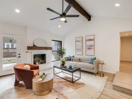 a living room with furniture and a fireplace