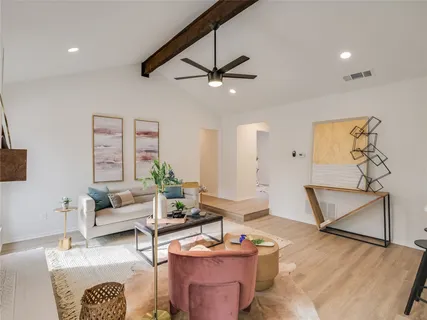 a living room with furniture and wooden floor