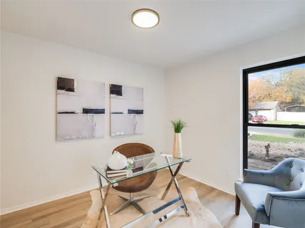 a living room with furniture and a floor to ceiling window