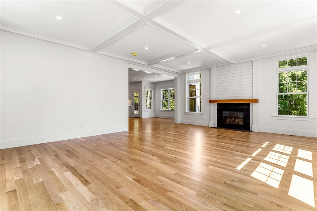 1 Elm Street Middleton, MA 01949 - Photo 13 of 42 an empty room with wooden floor fireplace and windows