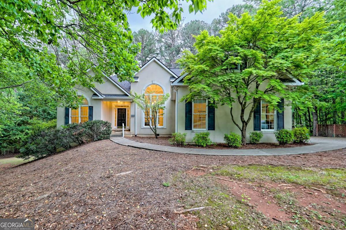 a front view of a house with a garden and porch