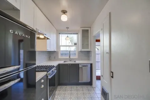 a view of backyard with small cabin and wooden fence