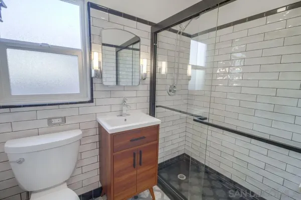a kitchen with granite countertop a sink a stove top oven and cabinets