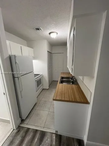 a refrigerator freezer sitting inside of a kitchen