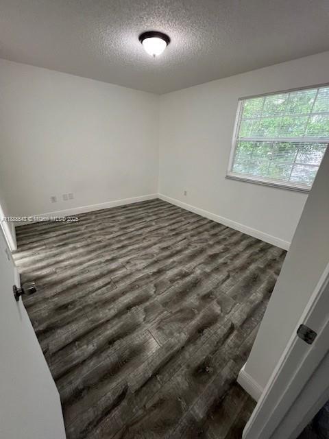 18336 Northwest 68th Avenue, Unit L Hialeah, FL 33015 - Photo 12 of 14 a view of a room with wooden floor
