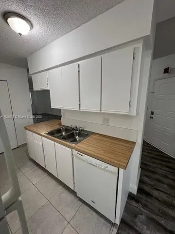 a kitchen with stainless steel appliances a sink stove and cabinets