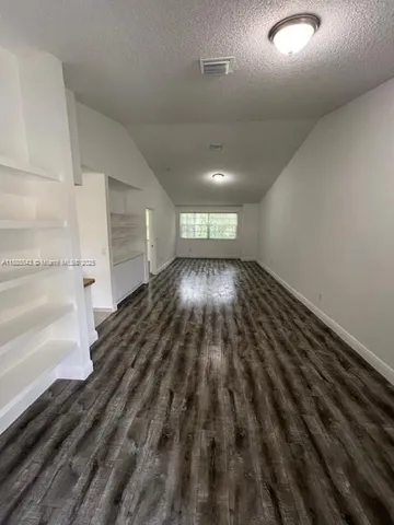 a view of an empty room and wooden floor