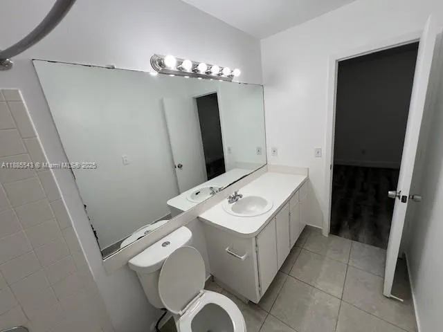 a bathroom with a sink a toilet and mirror