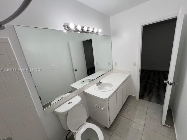 18336 Northwest 68th Avenue, Unit L Hialeah, FL 33015 - Photo 8 of 14 a bathroom with a sink a toilet and mirror