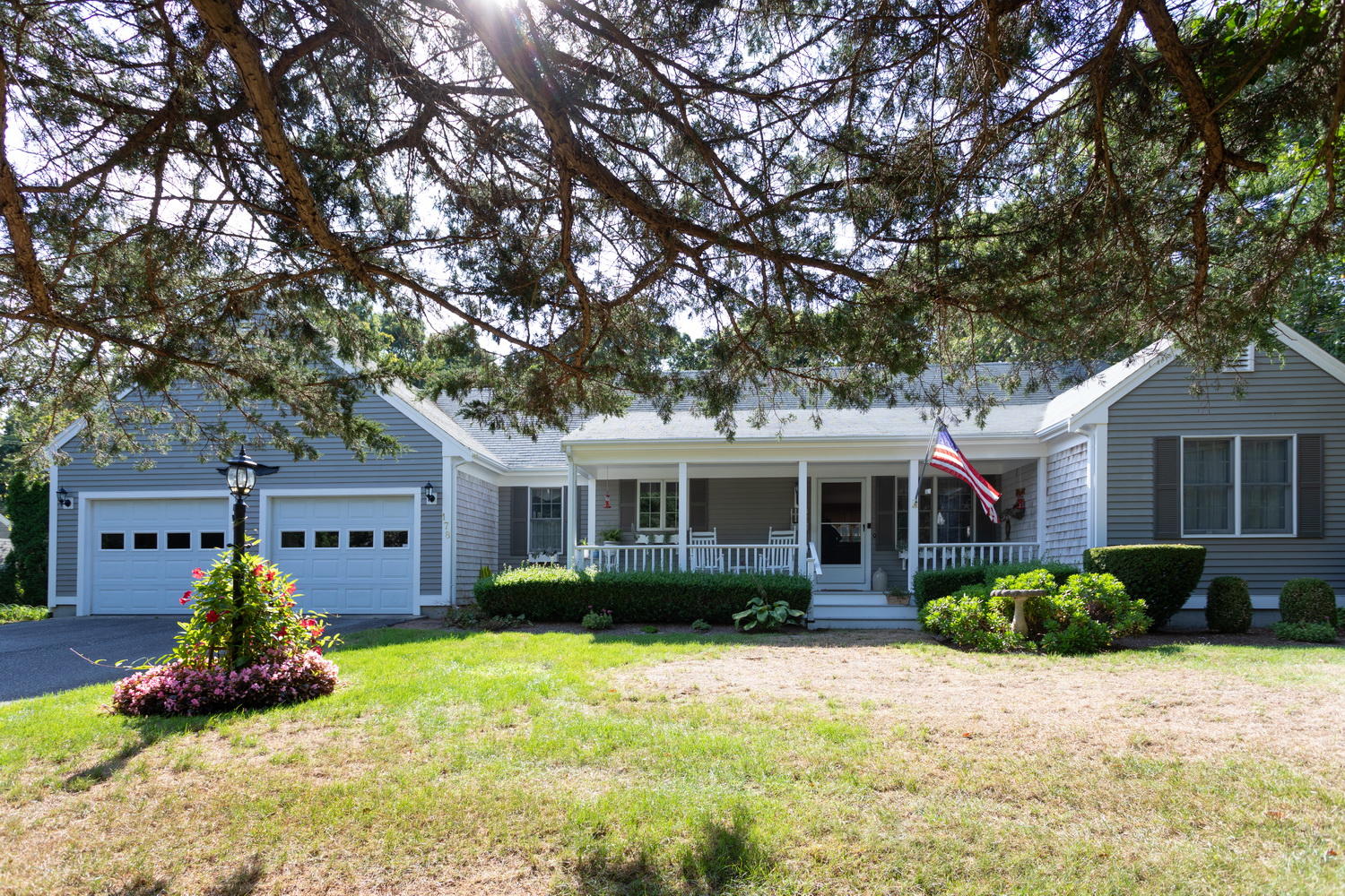 a front view of house with yard and trees around