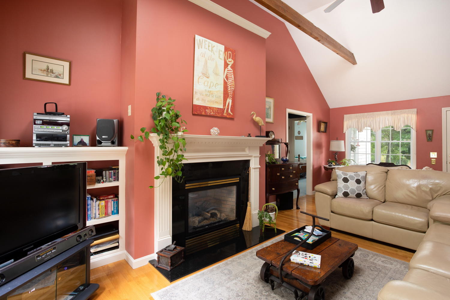 178 Winding Cove Road Marstons Mills, MA 02648 - Photo 10 of 17 a living room with furniture a flat screen tv and a fireplace