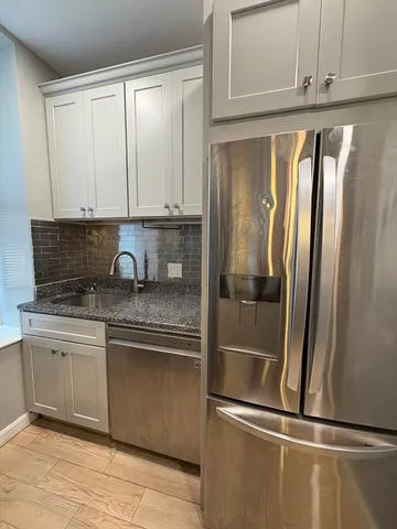 a stove top oven sitting inside of a kitchen