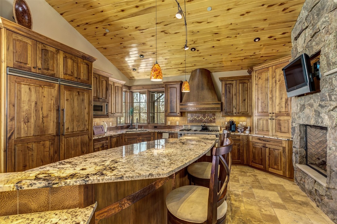 1680 Golden Eagle Road Silverthorne, CO 80498 - Photo 11 of 40 a kitchen with stainless steel appliances granite countertop a sink and cabinets