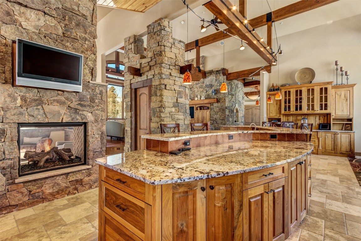 1680 Golden Eagle Road Silverthorne, CO 80498 - Photo 12 of 40 a view of a kitchen with a sink and a fireplace