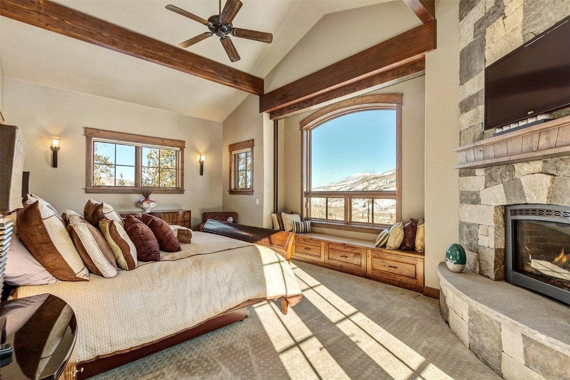 1680 Golden Eagle Road Silverthorne, CO 80498 - Photo 14 of 40 a living room with furniture a flat screen tv and a fireplace